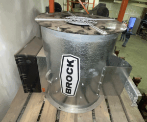 24-inch Brock in-line centrifugal grain bin fan resting on a pallet inside a workshop