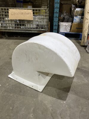 Used Bulktech roof vent with curved weather‑shield housing resting on a warehouse floor.