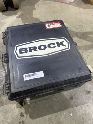 Used Brock fan electrical enclosure with Brock logo on the lid, shown on a shop floor.
