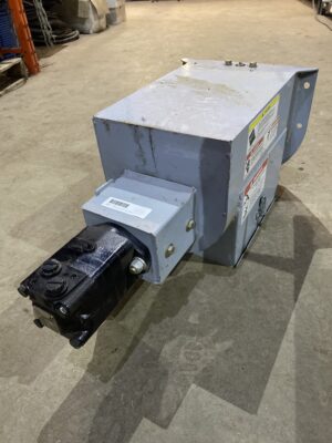 Norstar hydraulic power head assembly with hydraulic motor, steel housing, and mounting bracket resting on a concrete floor.