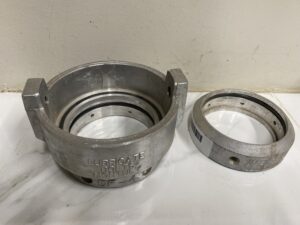 Walinga DM‑4 and DF‑4 aluminum couplers with sealing rings displayed on a white surface.