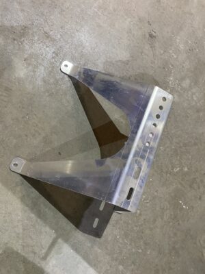 aluminum wall standoff bracket for Walinga pipe with multiple mounting holes lying on a concrete floor.