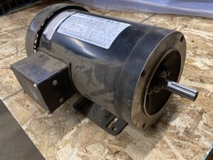 Side view of a JLEM 1.5 HP electric motor showing the cast‑iron housing, junction box, and mounting feet.
