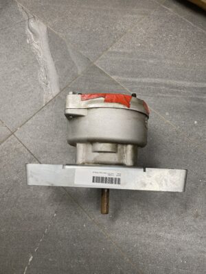 Side profile of a Brock grain spreader gear reducer with cast housing and output shaft extending downward.