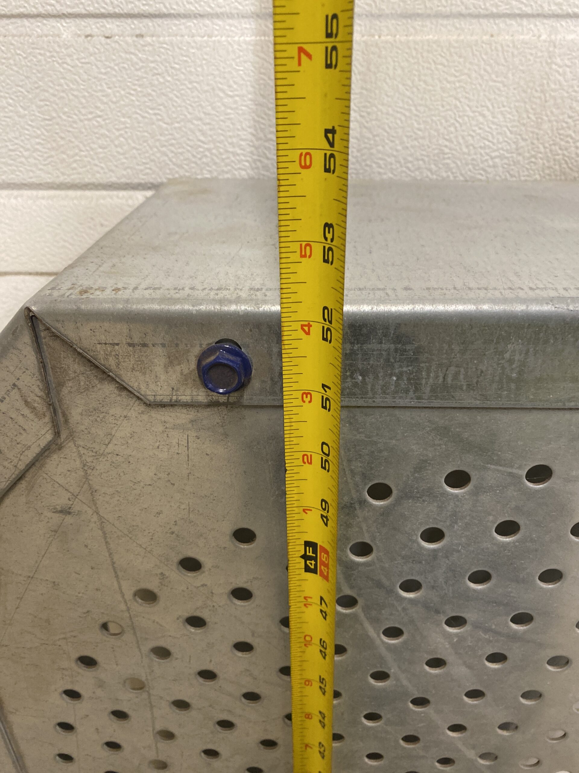 Vertical tape measure against a Lambton belt guard showing an overall length of approximately 52 inches.