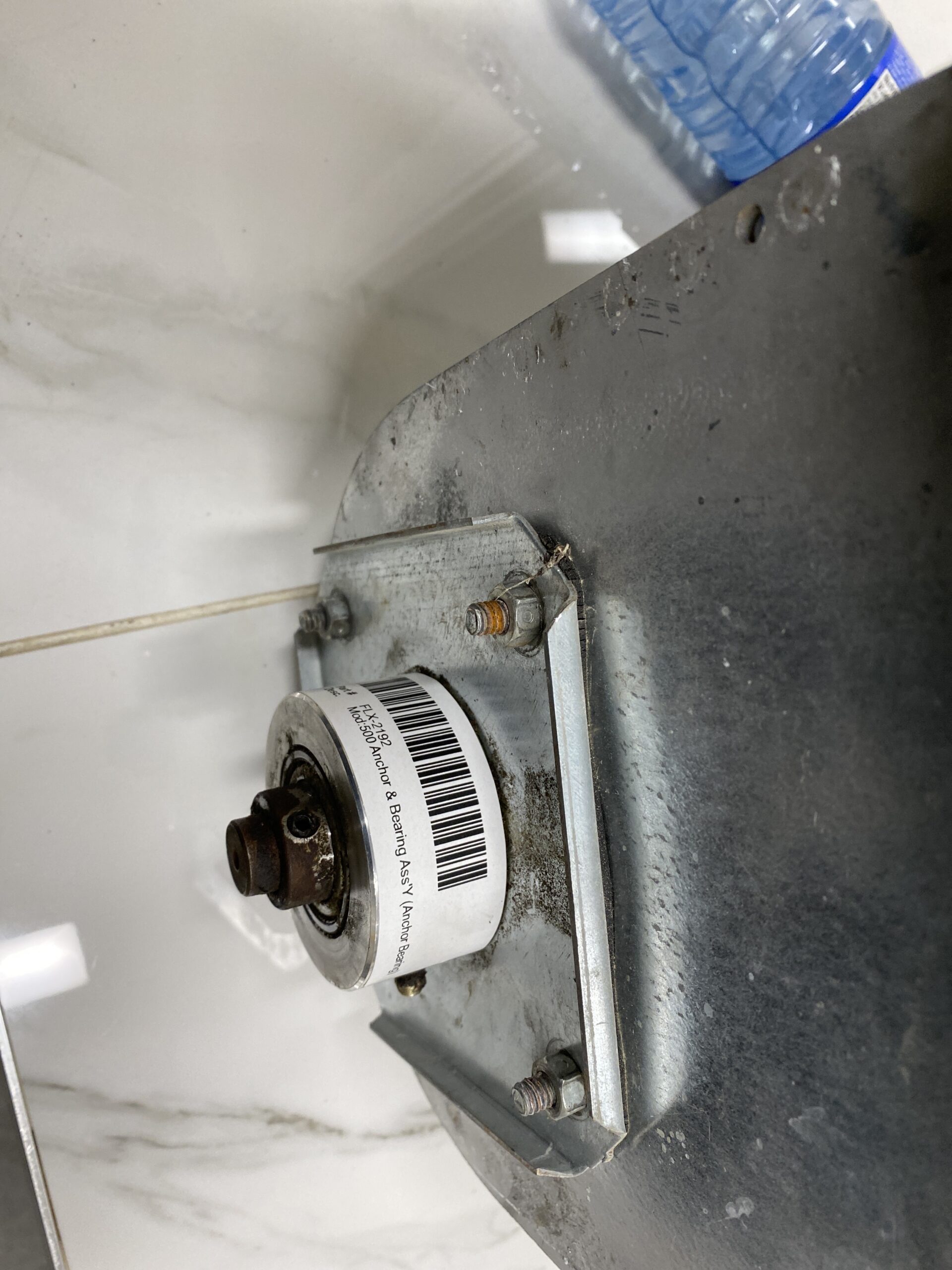 RAD flex auger anchor and bearing assembly mounted to the unloader housing, showing shaft and bearing plate.