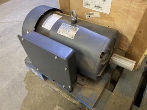 Side view of a Techtop 10 HP single‑phase farm duty motor showing the shaft, lifting eye, and junction box.
