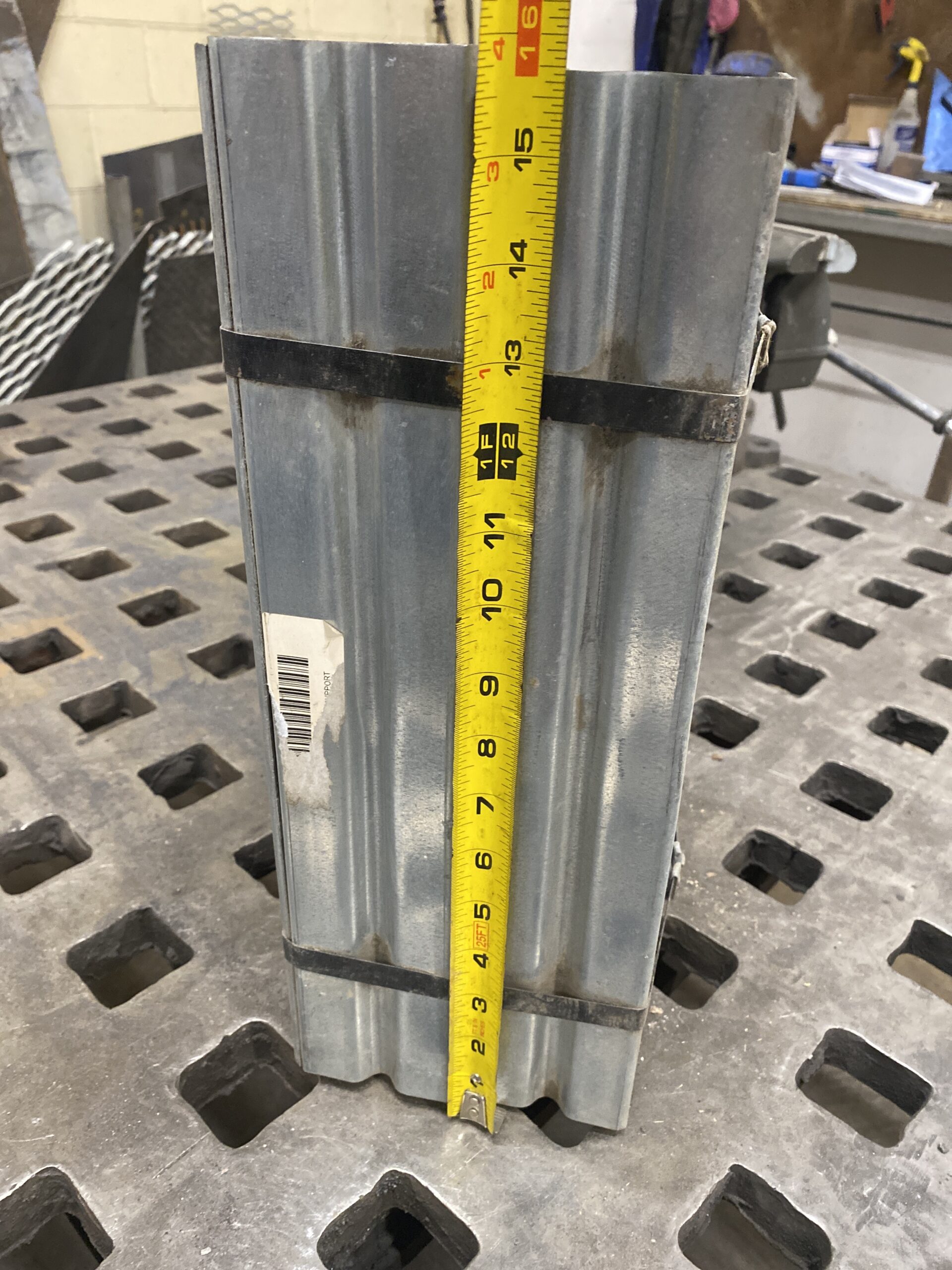Bundle of Shivvers galvanized floor support legs with a tape measure showing approximately 16 11/16 inches in height.