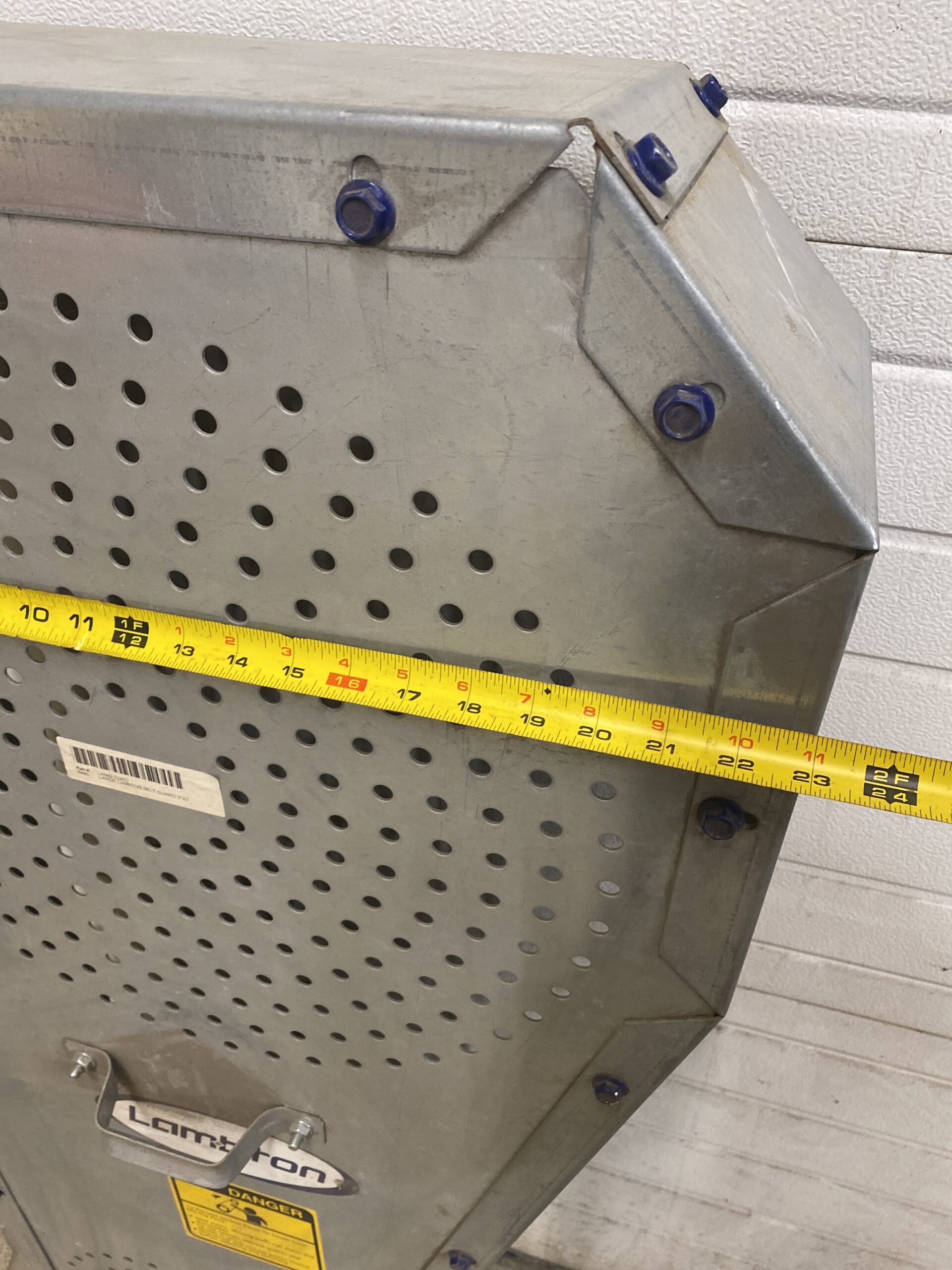 Lambton galvanized belt guard with tape measure showing approximately 23 inches wide.