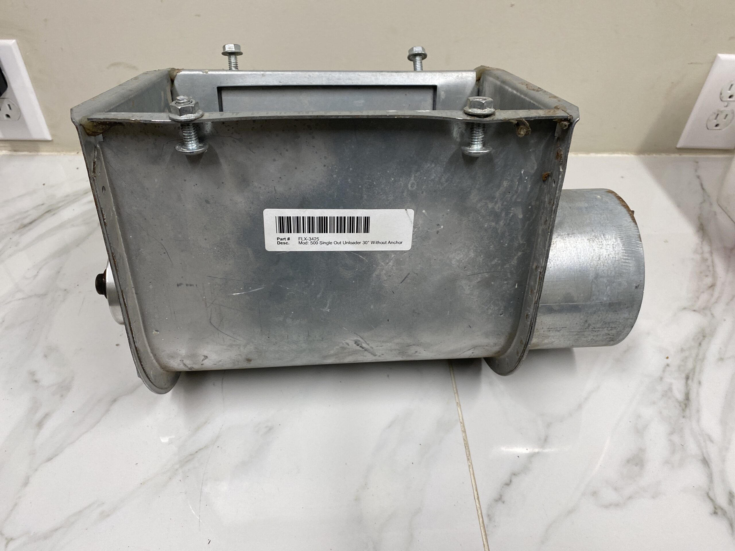 Side view of the RAD Model 500 flex auger unloader showing the galvanized hopper, intake tube, and mounting bolts.