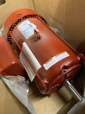 New Leeson 7.5 HP farm duty electric motor resting inside its original cardboard box.