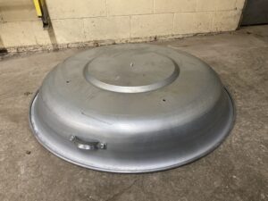 Top view of a new Brock grain bin lid with domed galvanized steel design.