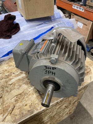 Front view of a Tatung 3 HP 575V motor showing the output shaft, front bearing housing, and junction box.