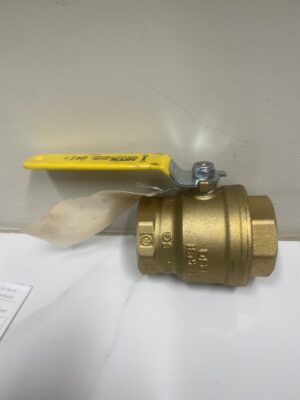 A 2-inch brass ball valve with a yellow lever handle resting on a white surface.